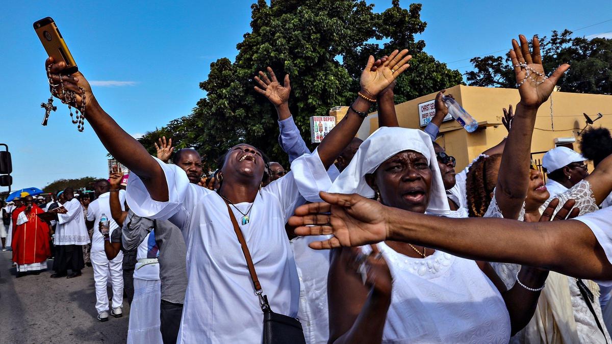 Members of Notre Dame d’Haiti Catholic Mission walk through the streets of Miami’s Little Haiti neighborhood in commemoration of the passion and Crucifixion of Jesus Christ on Good Friday, April 19, 2019. This year, the Good Friday service was held indoors due to the pandemic.