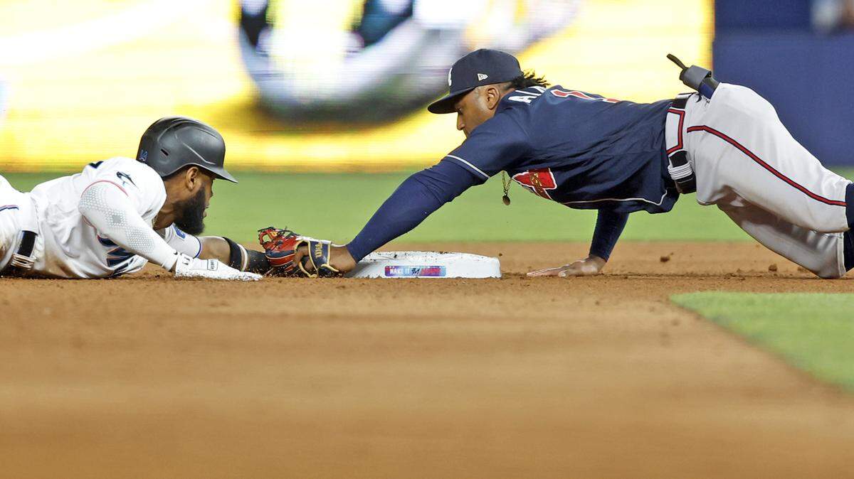 Miami Marlins left fielder Bryan De La Cruz (14) slides past second base allowing Atlanta Braves second baseman Ozzie Albies (1) to tag him out in the seventh inning at loanDepot Park in Miami on Tuesday, May 2, 2023.