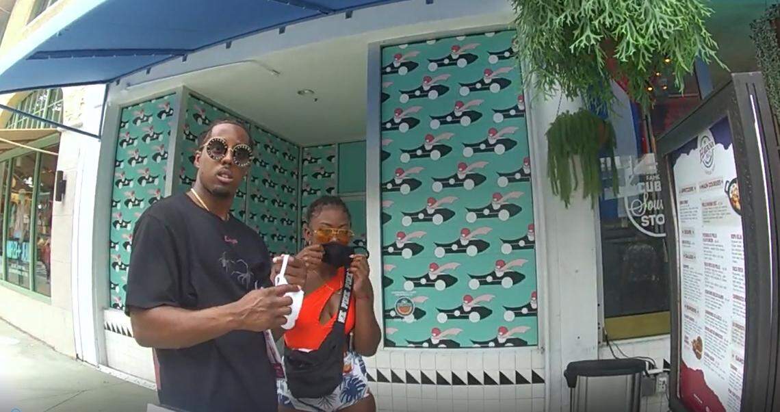 A man is stopped by a Miami Beach Code Compliance officer on July 23. He was fined $50 for violating the city’s face-mask rule, intended to slow the spread of the coronavirus.