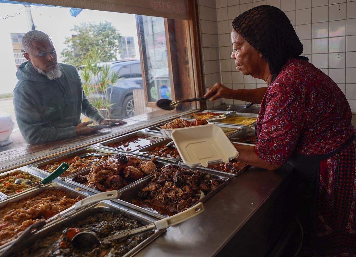 Melisanne Craan, right, prepares a to-go order for a regular customer at Naomi's Garden in Little Haiti, Thursday, Jan. 15, 2026, in Miami, Florida.