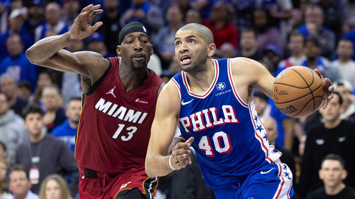 Philadelphia 76ers forward Nicolas Batum (40) drives past Miami Heat center Bam Adebayo (13) during the fourth quarter of a play-in game of the 2024 NBA playoffs at Wells Fargo Center.