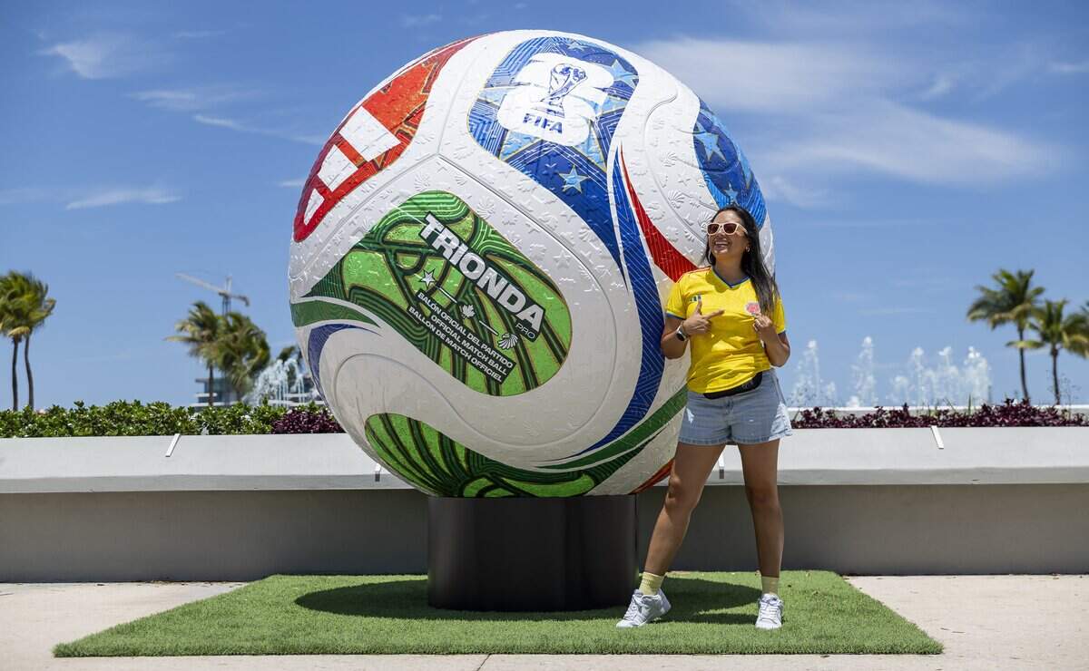 Paola Trivino takes a photo in front of a large soccer ball during the FIFA Fan Festival Miami at Bayfront Park on Saturday, June 13, 2026, in downtown Miami, Fla.
