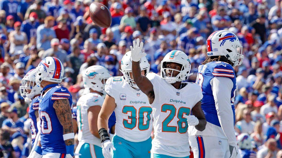 Miami Dolphins running back De’Von Achane (28) tosses the ball towards the stands after scoring against the Buffalo Bills at Highmark Stadium in Orchard Park, NY., on Sunday, October 1, 2023.