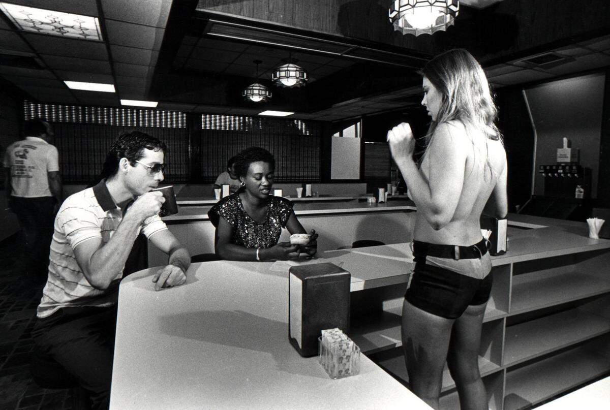 In 1985, a waitress helps customers at R Donuts in Fort Lauderdale.
