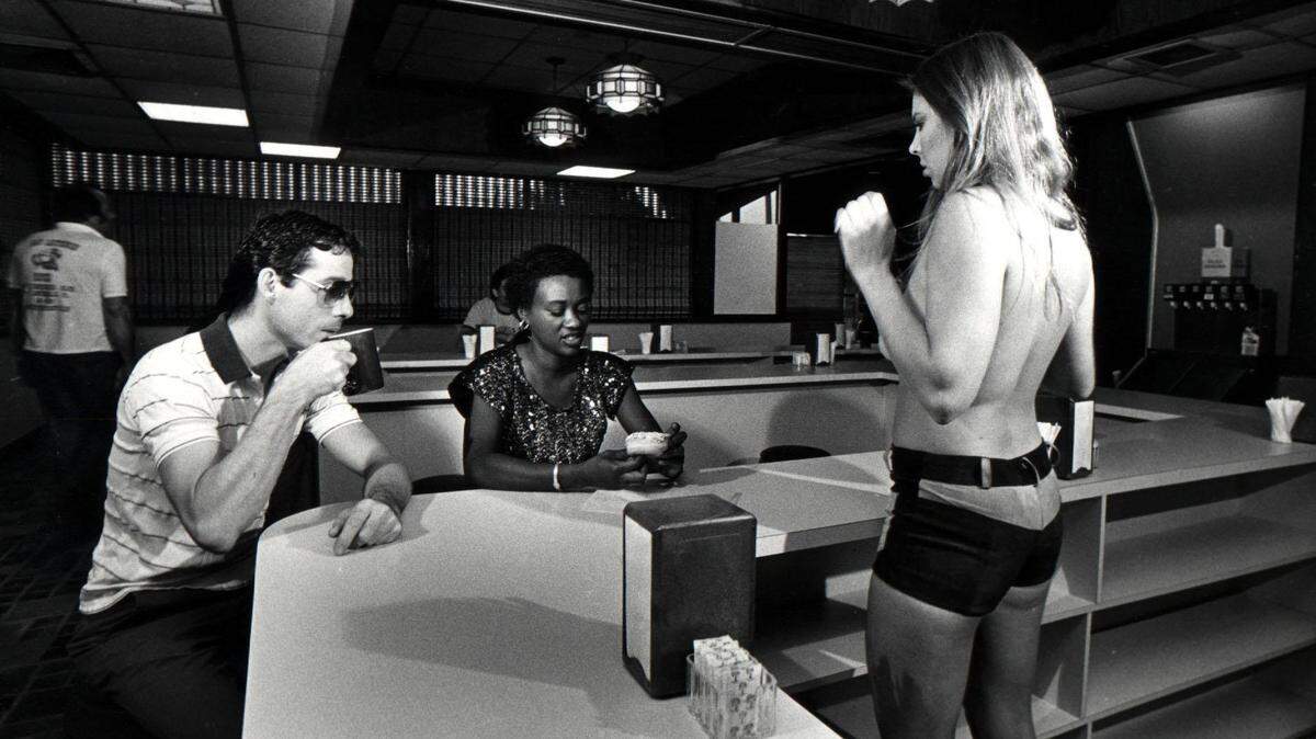 In 1985, a waitress helps customers at R Donuts in Fort Lauderdale.