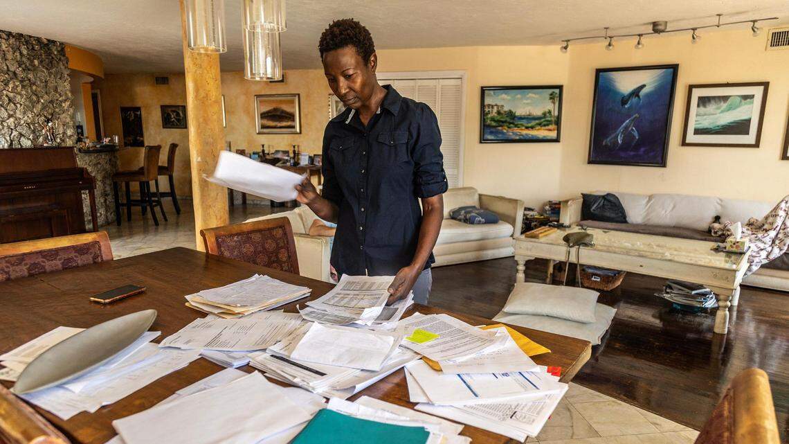 Sipiwe Anderson, a condo owner, looks at paperwork related to her special assessment on June 10, 2023 for her condo in Miami Beach.