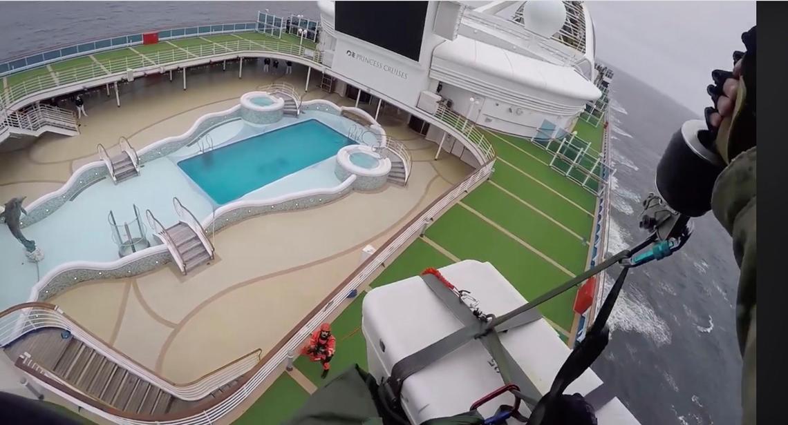 In this image from video, provided by the California National Guard, airmen with the 129th Rescue Wing drop coronavirus testing kits down to the Grand Princess cruise ship off the coast of California Thursday, March 5, 2020.