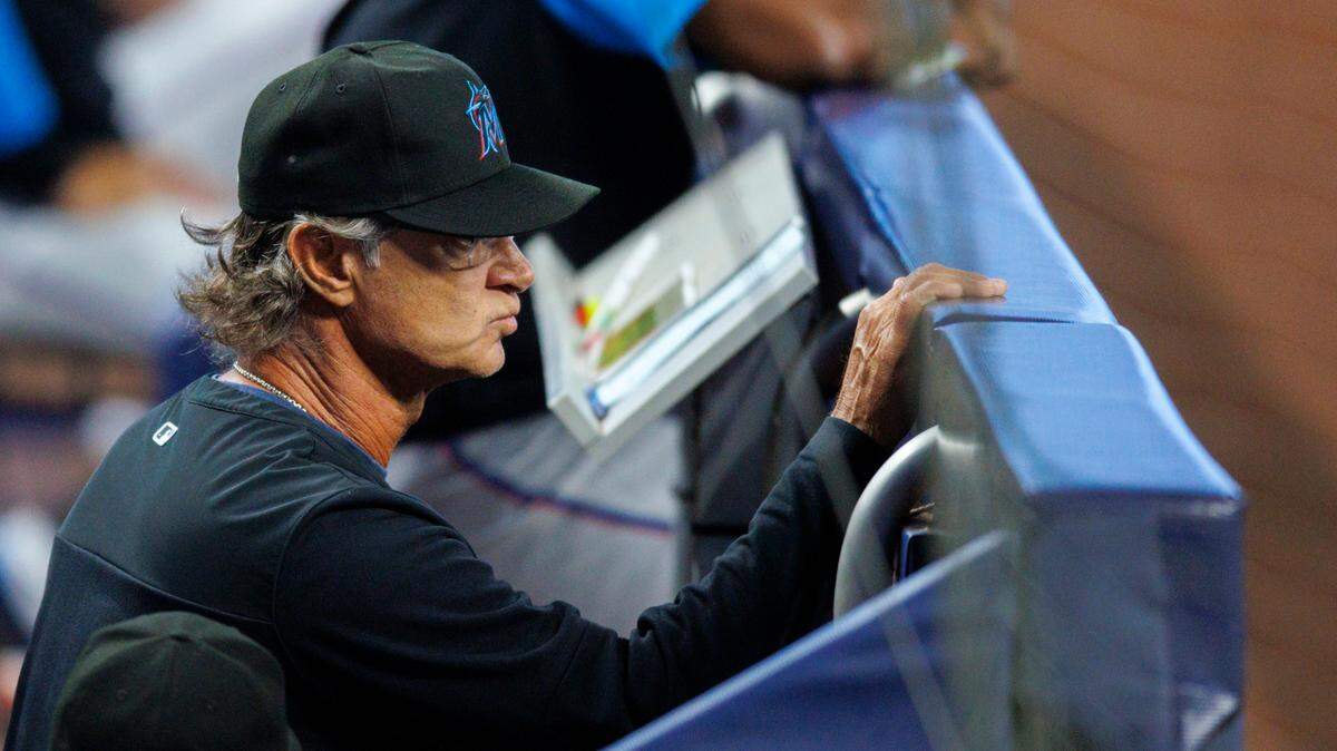 Miami Marlins manager Don Mattingly (8) looks from the dugout during the first inning of a baseball game against the Arizona Diamondbacks at LoanDepot Park on Wednesday, May 4, 2022 in Miami, Florida.