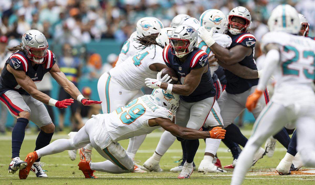 Miami Dolphins safety Minkah Fitzpatrick (29) tackles New England Patriots running back Antonio Gibson (4) in the first half of their NFL game at Hard Rock Stadium on Sunday, Sept. 14, 2025, in Miami Gardens, Fla.
