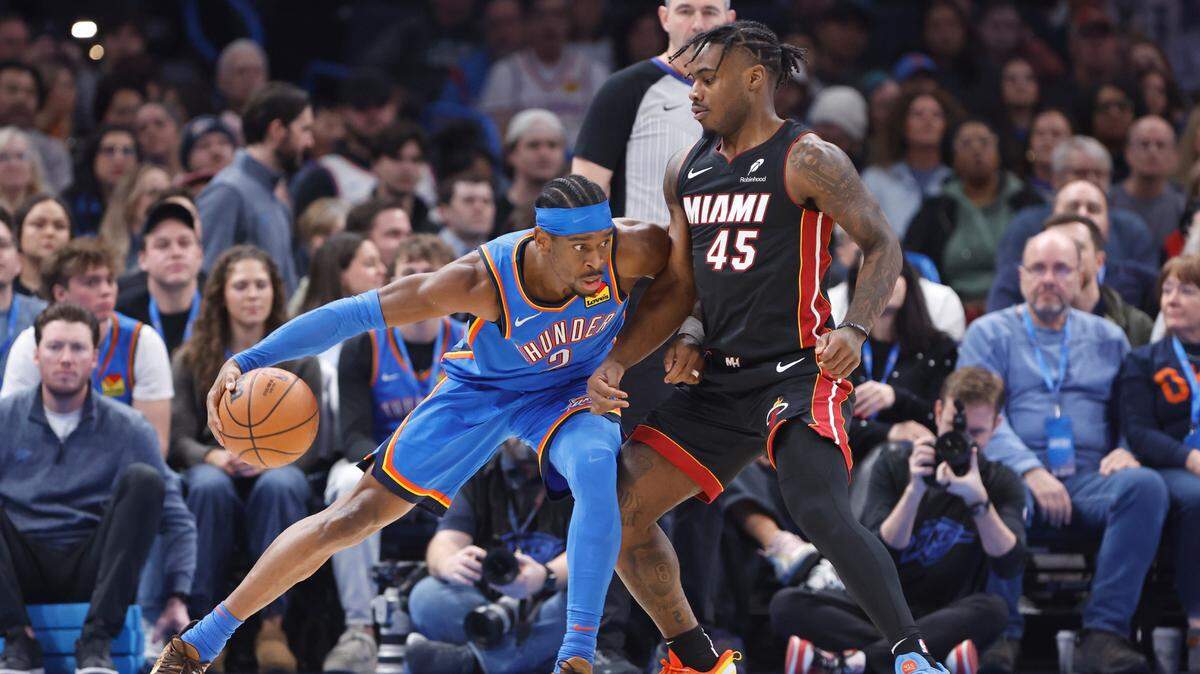 Miami Heat guard Davion Mitchell (45) defends a drive by Oklahoma City Thunder guard Shai Gilgeous-Alexander (2) during the first quarter at Paycom Center.