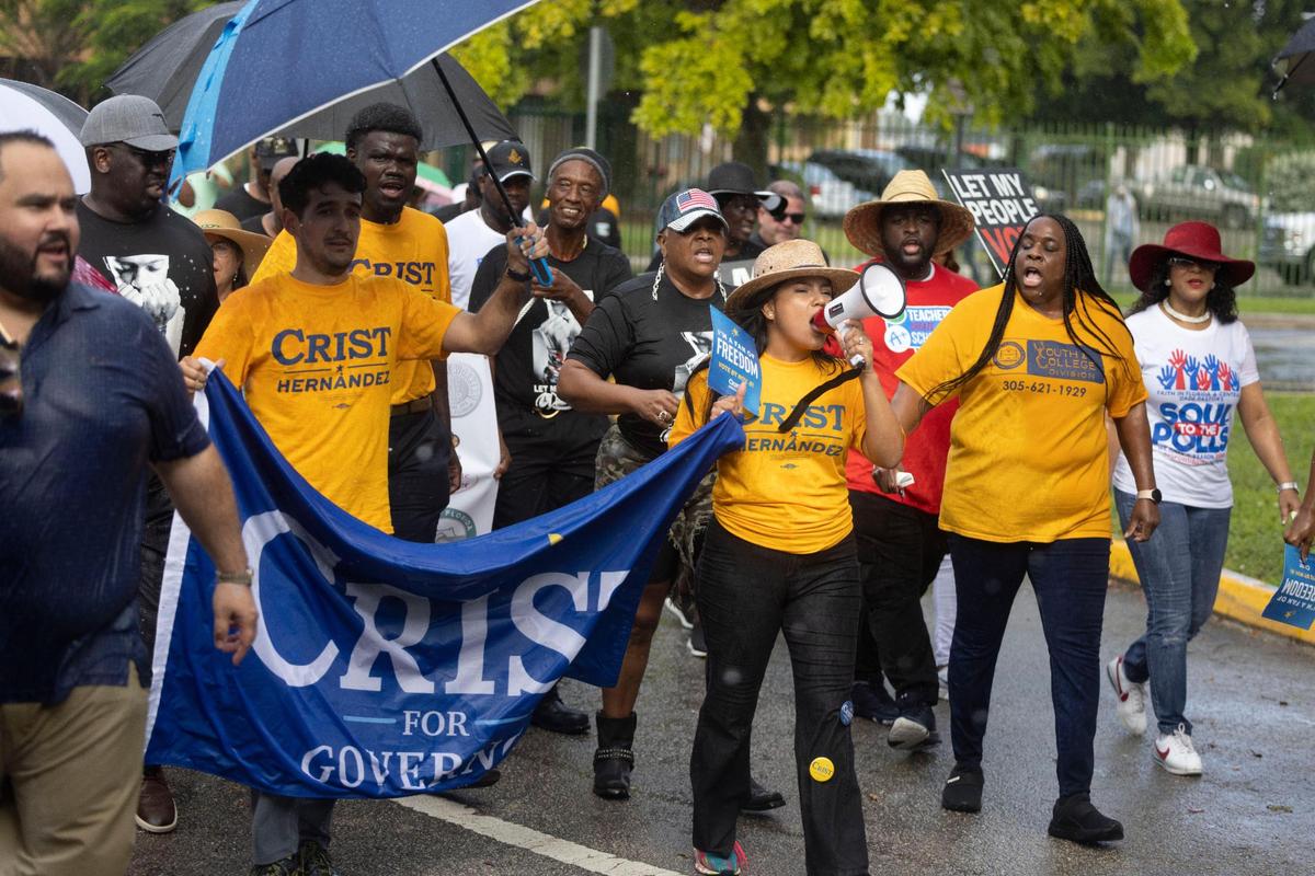 Karla Hernandez-Mats, the Democratic candidate for lieutenant governor, leads the march through the rain during a Souls to the Polls event on Sunday, Nov. 6, 2022, in Liberty City. The march started at the African Heritage Cultural Arts Center and ended at the Joseph Caleb Center, an early voting location.