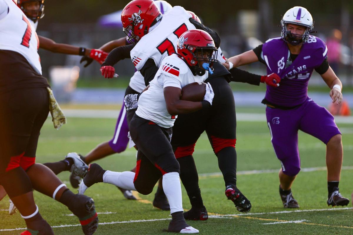 Edison Red Raiders running back Sterling Joseph (4) runs with the football against True North Titans during the first quarter of a high school football Class 1A Region 4 playoff game at Tropical Park in Miami, Florida, on Thursday, November 21, 2024.