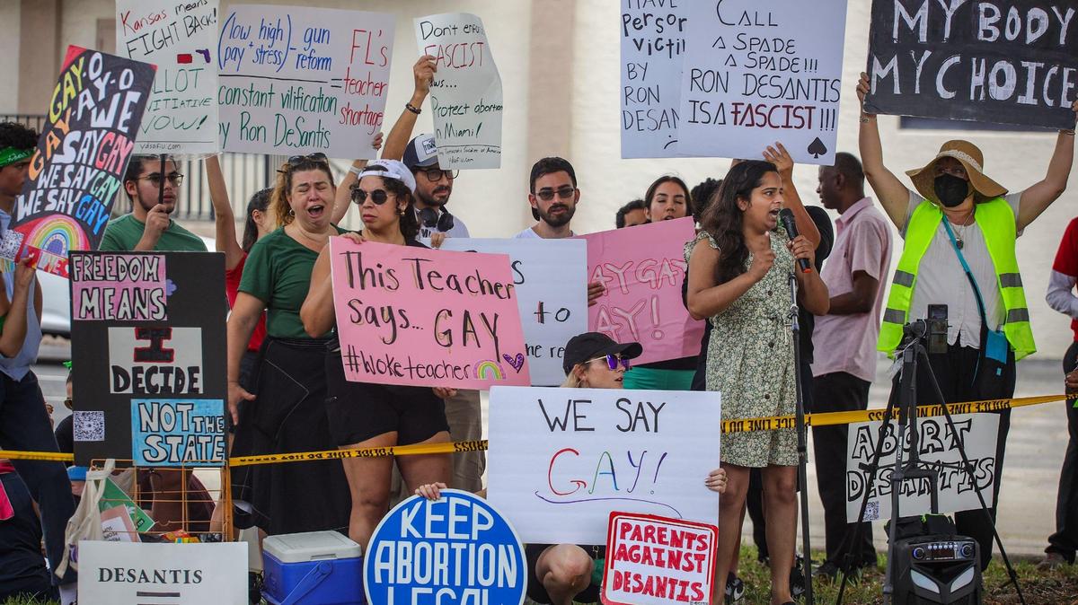 Transgender protester Avani, 28, right-center, rallies the crowd gathered outside the Metro-Dade Firefighters Local 1403 in Doral, Florida, where Gov. Ron DeSantis spoke at a campaign event in 2022.