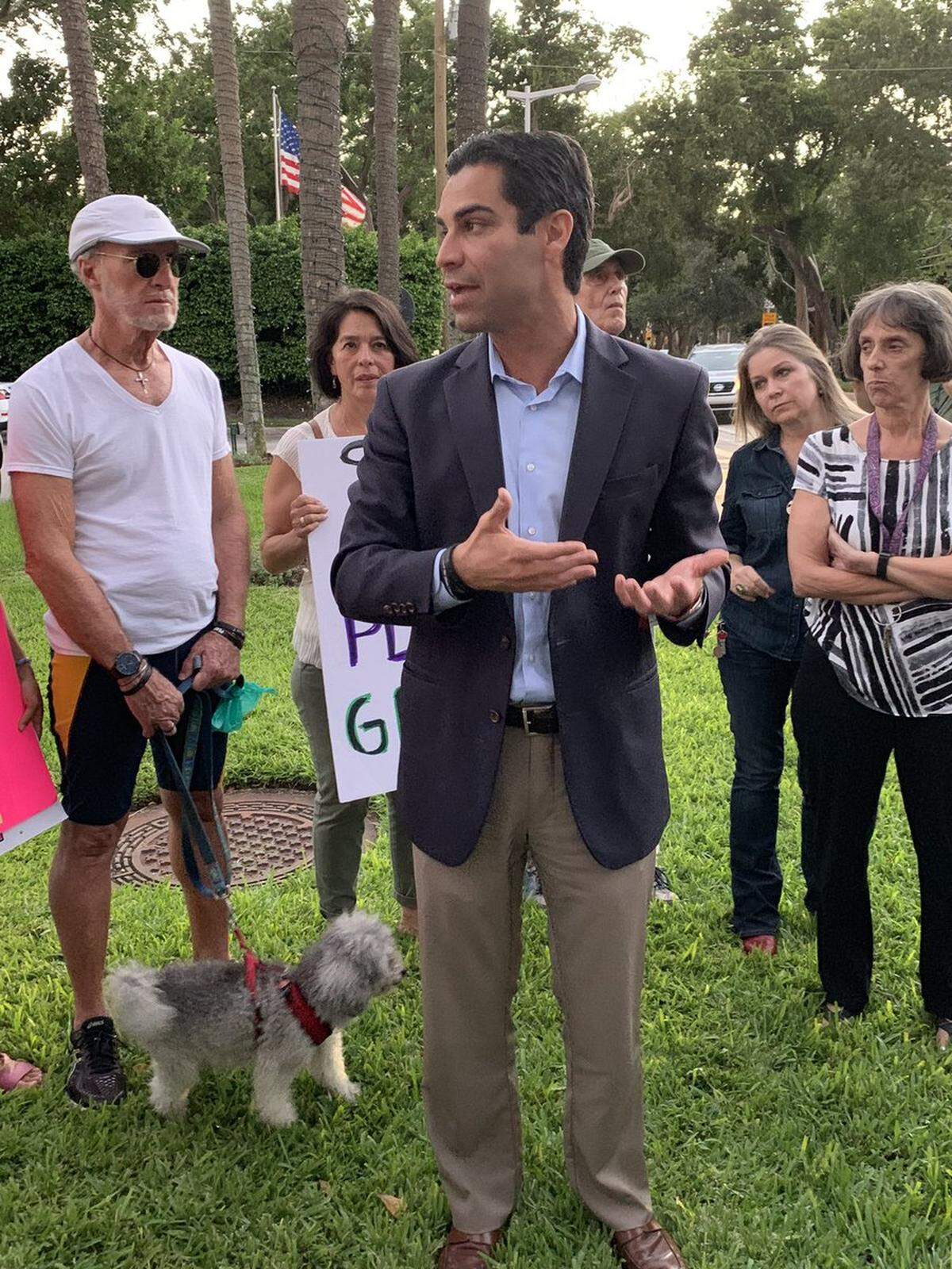 Miami Mayor Francis Suarez talks with Brickell residents during their demonstration against artificial grass. He has ordered the grass removed.