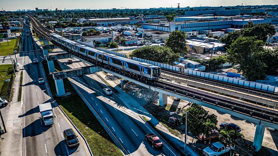 View of the Metrorail traveling north on Northwest 27th approaching the Northside Metro Rail Station. The Miami-Dade sales tax helps fund the Metrorail system.