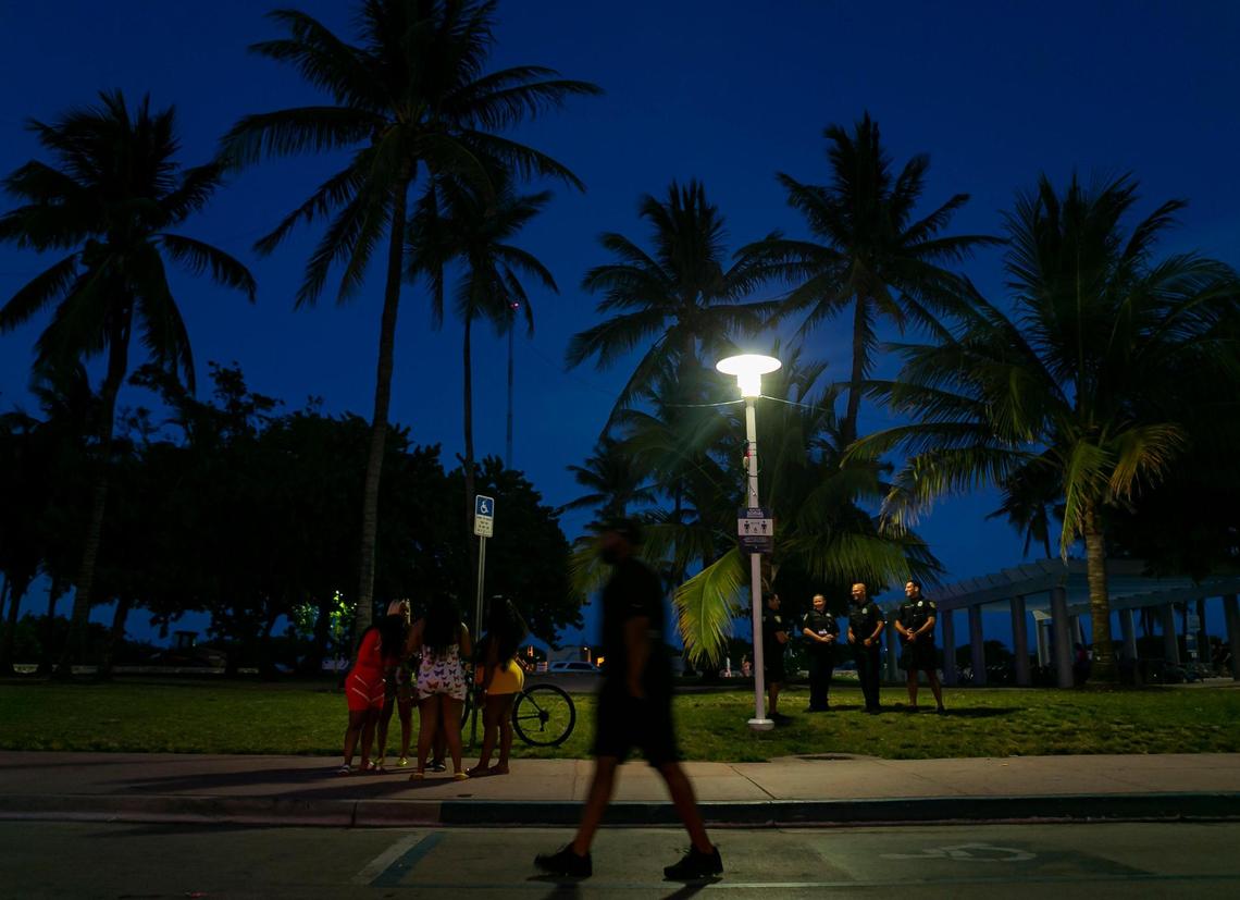 South Beach visitors make their way down Ocean Drive in Miami Beach, Florida during the start of Memorial Day Weekend on Friday, May 28, 2021.