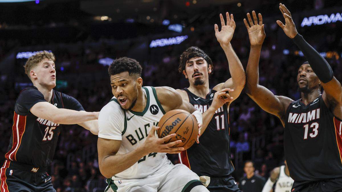 Miami Heat guard Kasparas Jakucionis (25), guard Jaime Jaquez Jr. (11), and center/forward Bam Adebayo (13) defend against Milwaukee Bucks forward Giannis Antetokounmpo (34) during the fourth quarter of their NBA basketball game at Kaseya Center in Miami on March 12, 2026.
