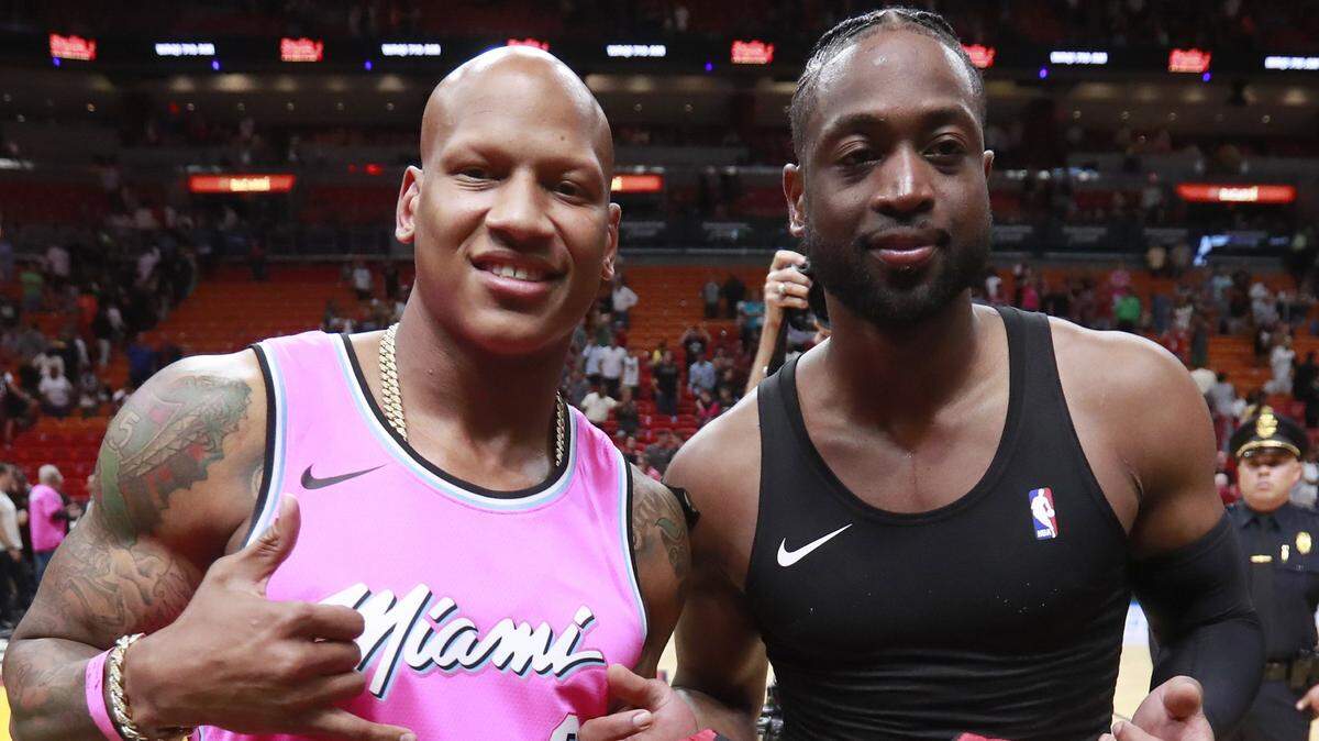 Miami Heat guard Dwyane Wade, right, poses with Pittsburgh Steelers linebacker Ryan Shazier after an NBA basketball game Friday, March 15, 2019, in Miami. Wade gave his game jersey to Shazier. The Milwaukee Bucks defeated the Heat 113-98. (AP Photo/Wilfredo Lee)