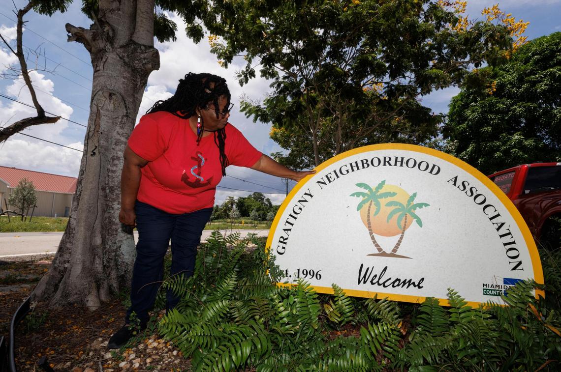 Joyce Brown, present of the Gratigny Homeowners Association, poses with the neighborhood sign in the Gratigny neighborhood in Miami, Fla.