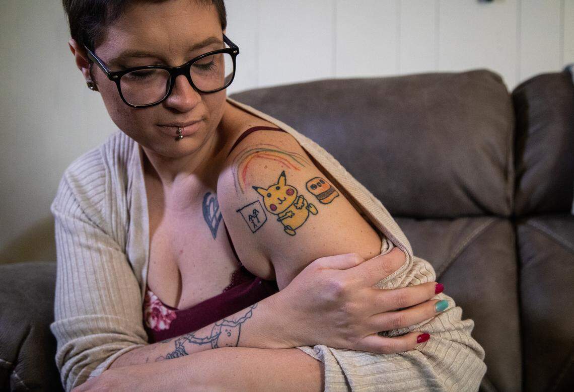 Amanda Simpson shows a set of tattoos in honor of her three children on Friday, Jan. 28, 2019, at her sister’s home in Chester, Virginia. Simpson’s ex-husband, Justin Tyler Painter, 39, shot and killed their three young children, Simpson’s boyfriend and then himself in Ponder, Texas, in May 2018.