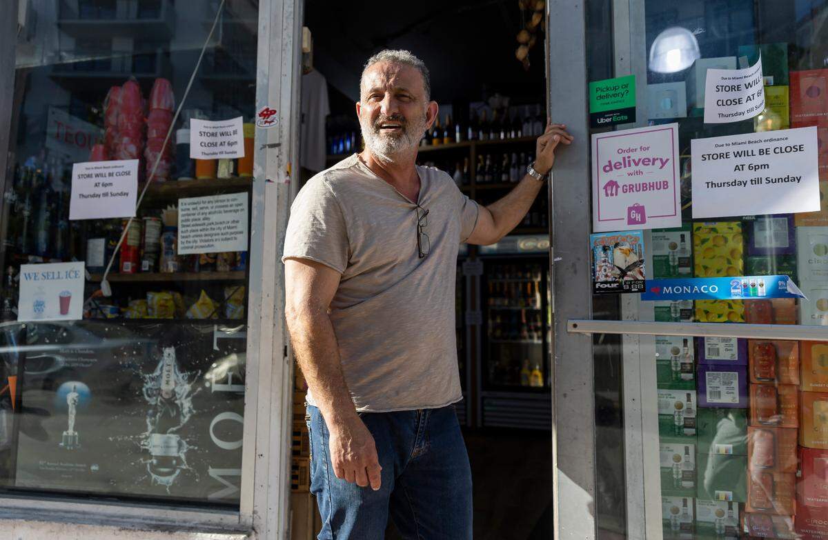 The storeowner of SOUTH BEACH LIQUOR stands outside of his store on Friday, March 24, 2023 in Miami Beach, Fla. After two deadly shootings, city officials voted not to re-impose a midnight curfew, but implemented an emergency order banning alcohol sales after 6 p.m.