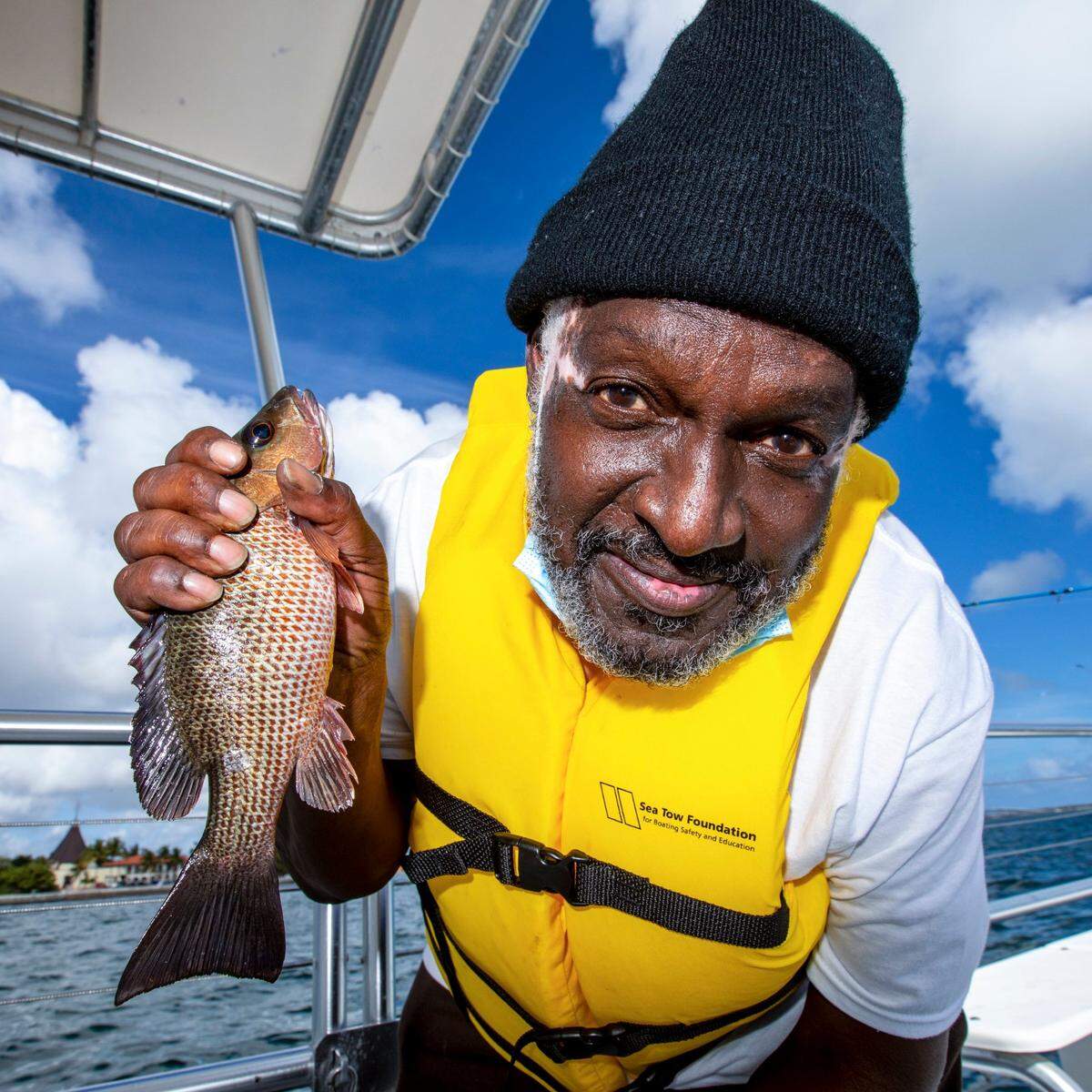 Lorenzo Latson, 60, holds up a fish he caught during a fishing trip out on Biscayne Bay as a part of the Disabled Veterans’ Program, designed to give soldiers and their families access to the water, at Shake-A-Leg Miami in Coconut Grove, Florida, on Wednesday, Feb., 17, 2021.