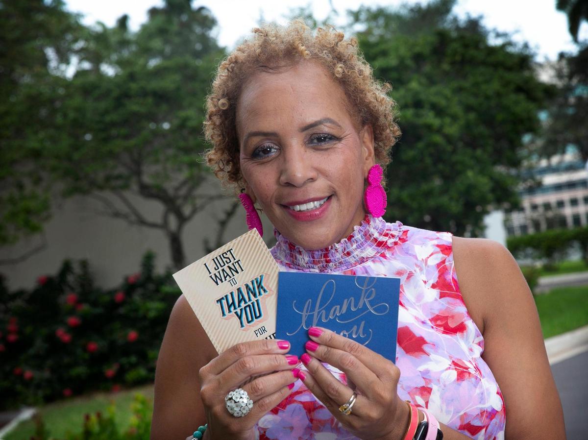Angela Taylor, sobreviviente de cáncer de seno y paciente de la Dra. Lauren Carcas, fue tratada en el Miami Cancer Institute, de Baptist Health en Plantation. El 8 de octubre de 2021, Taylor sostiene notas de agradecimiento que ha recibido de otras personas a las que ha ayudado durante su enfermedad. 