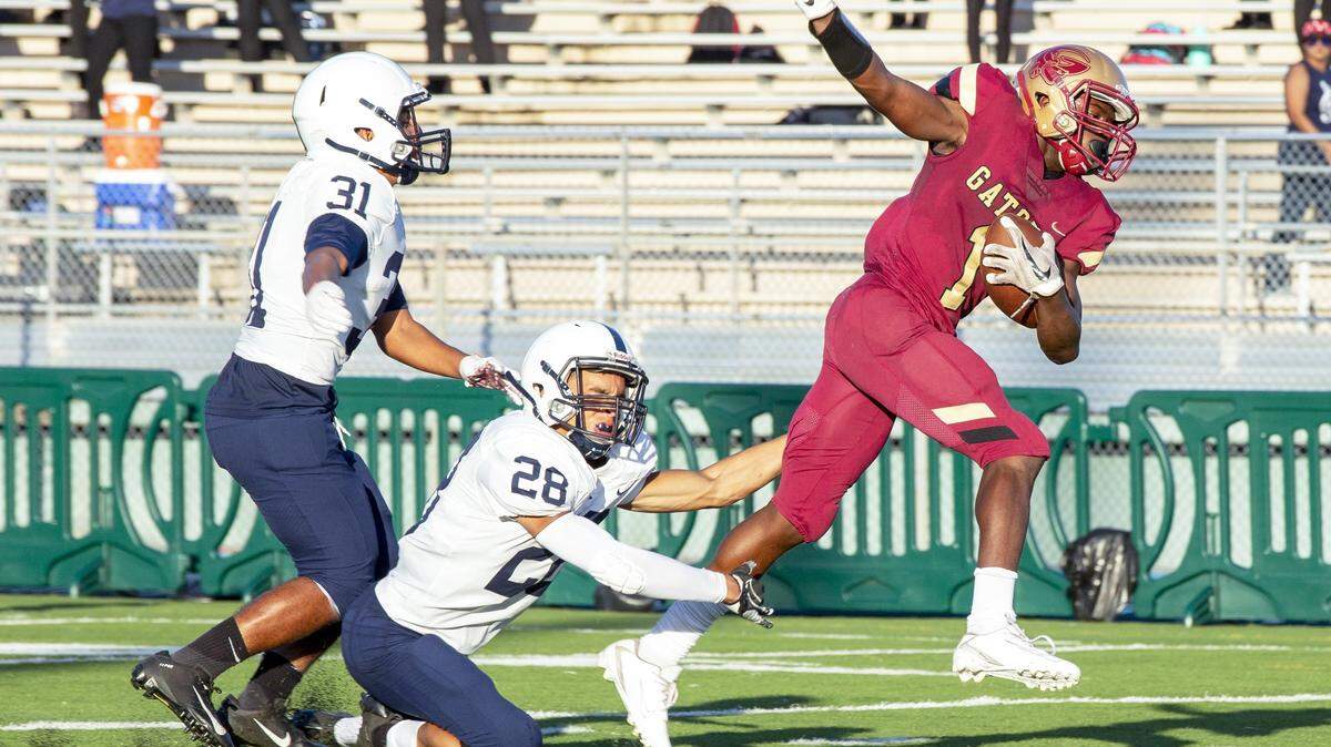 Goleman wide receiver Avari Marshall (1) avoids the tackle by Reagan cornerback Daniel Then (28) before scoring a touchdown during the fourth quarter of a football game at Traz-Powell Stadium on Thursday, October 31, 2019. Marshall had touchdown catches of 36, 80 and 27 yards.