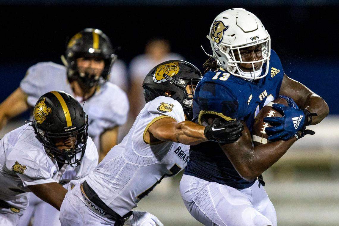 Florida International University tight end Rivaldo Fairweather (13) is tackled by Bryant University defensive back Jayvis Rayside (7) during an NCAA Conference USA football game at Riccardo Silva Stadium in Miami, Florida, on Thursday, September 1, 2022.