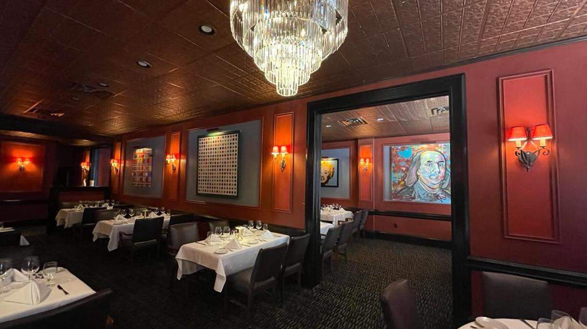 The new interior at Christy’s steakhouse includes chandeliers and gray walls to highlight new art.