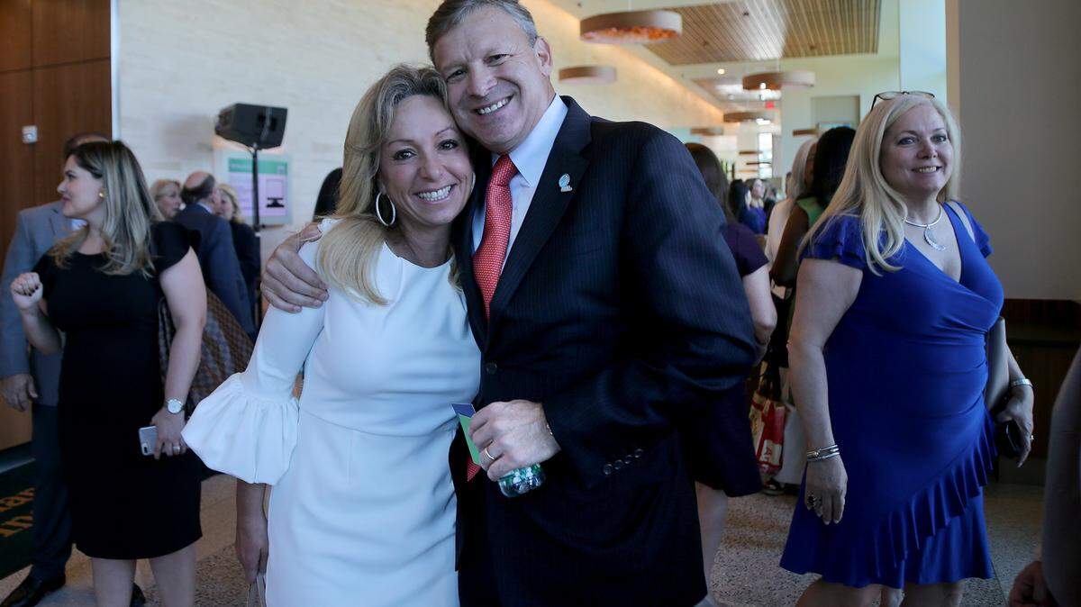 Eric Silagy, CEO of Florida Power & Light Company, embraces Sharon Prolow, a proton therapy patient, during a ceremony announcing that FPL is donating $1 million to the Miami Cancer Institute, part of Baptist Health South Florida. The donation will help support proton therapy to treat pediatric cancer patients with more precision.