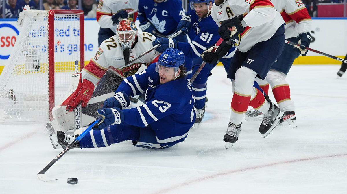 May 7, 2025; Toronto, Ontario, CAN; Toronto Maple Leafs left wing Matthew Knies (23) battles for the puck with Florida Panthers defenseman Aaron Ekblad (5) during the first period in game two of the second round of the 2025 Stanley Cup Playoffs at Scotiabank Arena.