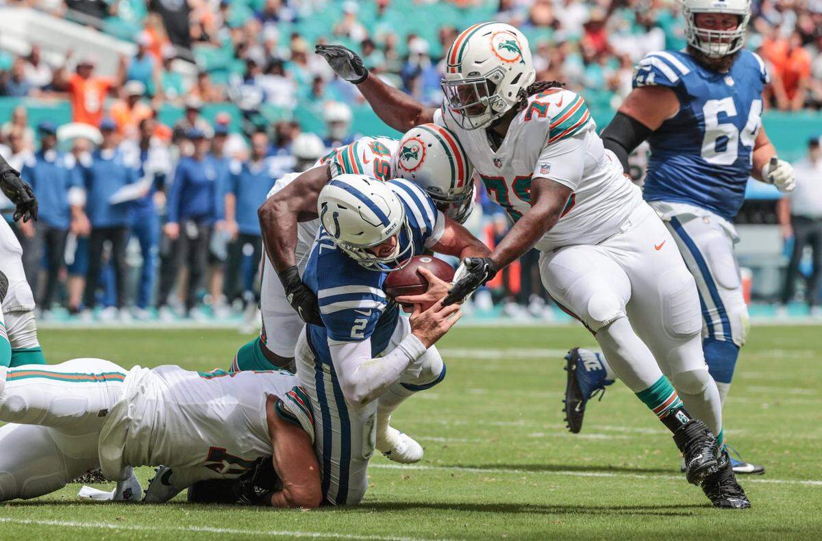 Indianapolis Colts quarterback Carson Wentz (2) is sacked by Miami Dolphins linebacker Jaelan Phillips (15) linebacker Sam Eguavoen (49) outside linebacker Shaquem Griffin (49) and nose tackle Adam Butler (70) in the first half at Hard Rock Stadium in Miami Gardens on Sunday, October 3, 2021.