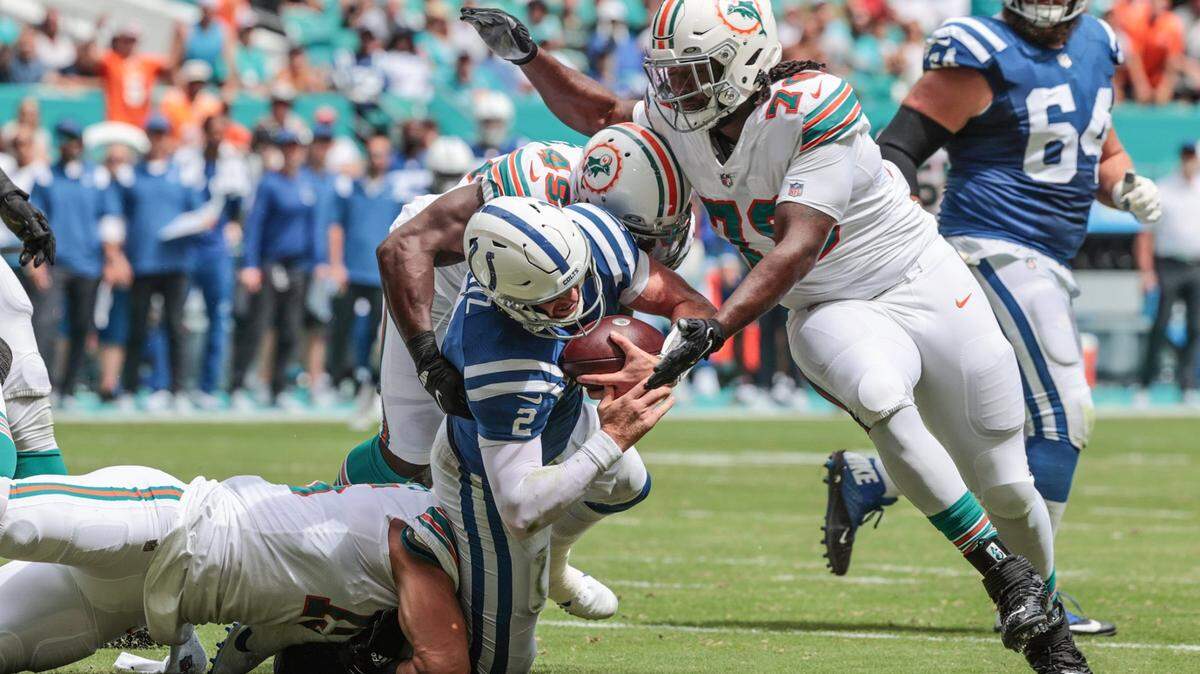 Indianapolis Colts quarterback Carson Wentz (2) is sacked by Miami Dolphins linebacker Jaelan Phillips (15) linebacker Sam Eguavoen (49) outside linebacker Shaquem Griffin (49) and nose tackle Adam Butler (70) in the first half at Hard Rock Stadium in Miami Gardens on Sunday, October 3, 2021.
