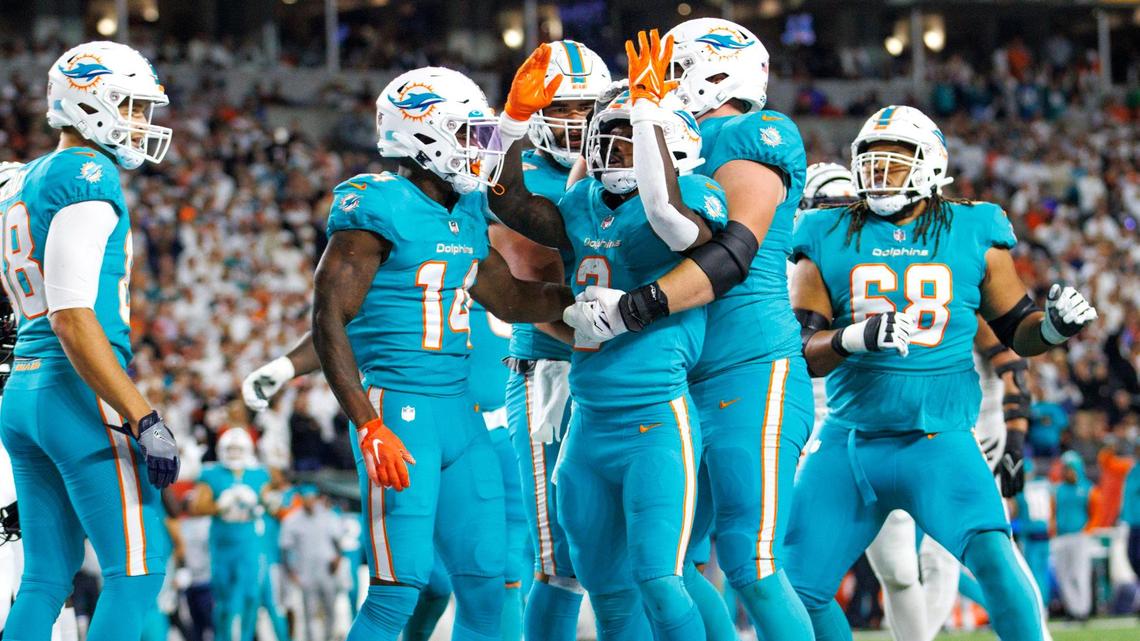 Miami Dolphins running back Chase Edmonds (2) celebrate with teammates after scoring a touchdown during the second quarter of an NFL football game at Paycor Stadium on Thursday, September 29, 2022 in Cincinnati, Ohio.