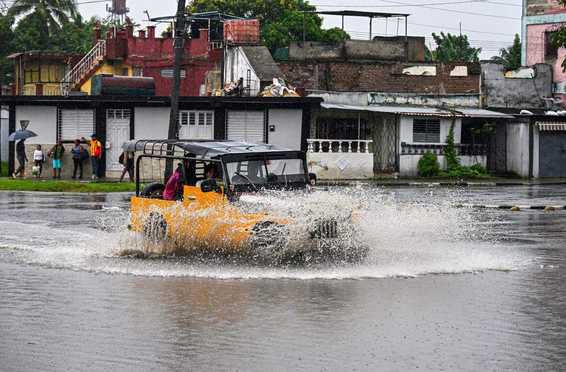Residents drive a car through flooded areas before Hurricane Melissa hits the city of Santiago de Cuba, Cuba on October 28, 2025. Hurricane Melissa was set to strike nearby eastern end of Cuba late Tuesday after pummeling Jamaica.