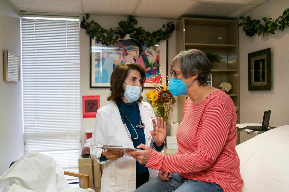 Dr. Linda Marraccini, left, talks with her patient Holly G. during a visit on Sept. 3, 2021. Holly asked that the Miami Herald not use her full last name for fear of backlash for her support of Marraccini’s patient vaccine mandate.