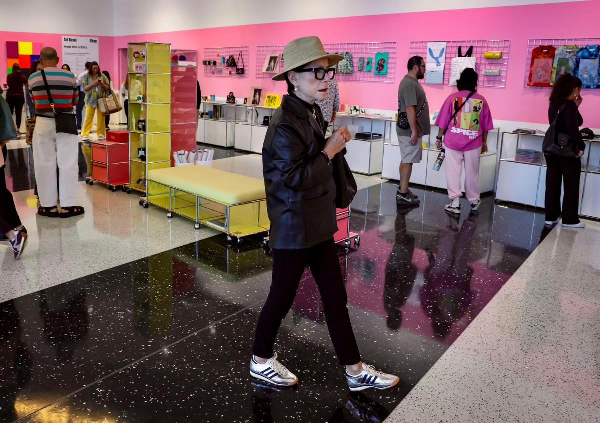 Guests visit the Art Basel store located at the entrance of the show at the Miami Beach Convention Center on Wednesday, Dec. 4, 2024, in Miami Beach, Fla.