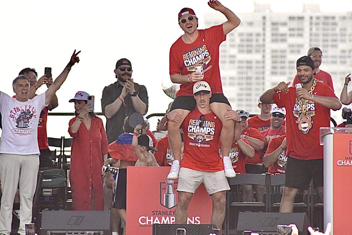 Florida Panthers forward Sam Reinhart makes his way to the stage on forward Brad Marchand’s shoulders during the team’s Stanley Cup championship celebration parade on Sunday, June 22, 2025, at Fort Lauderdale Beach, Florida.
