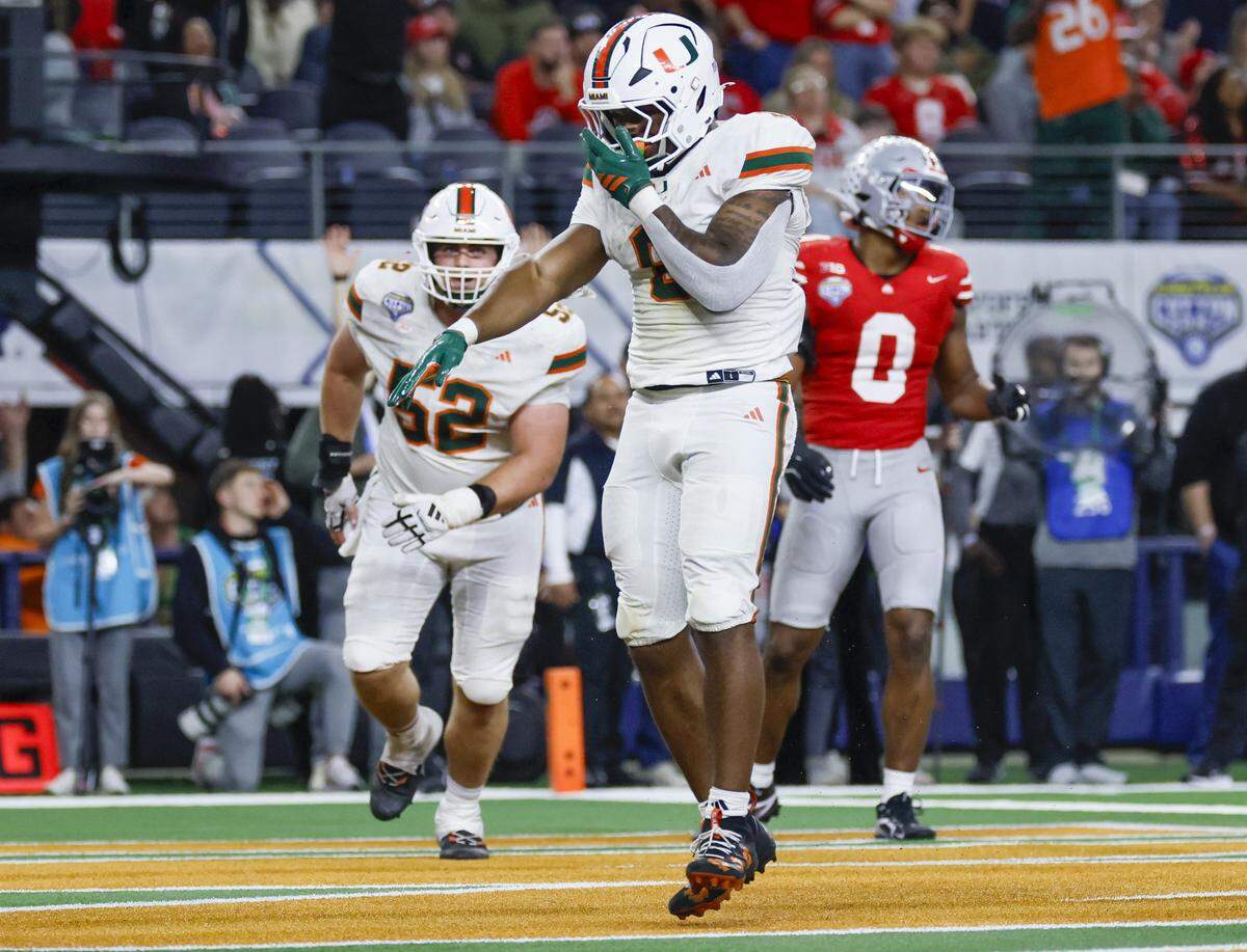 Miami Hurricanes running back Charmar Brown (6) reacts after scoring late in the second half of the College Football Playoff quarterfinal game against the Ohio State Buckeyes in the Cotton Bowl at AT&T Stadium in Arlington, Texas on Wednesday, December 31, 2025.