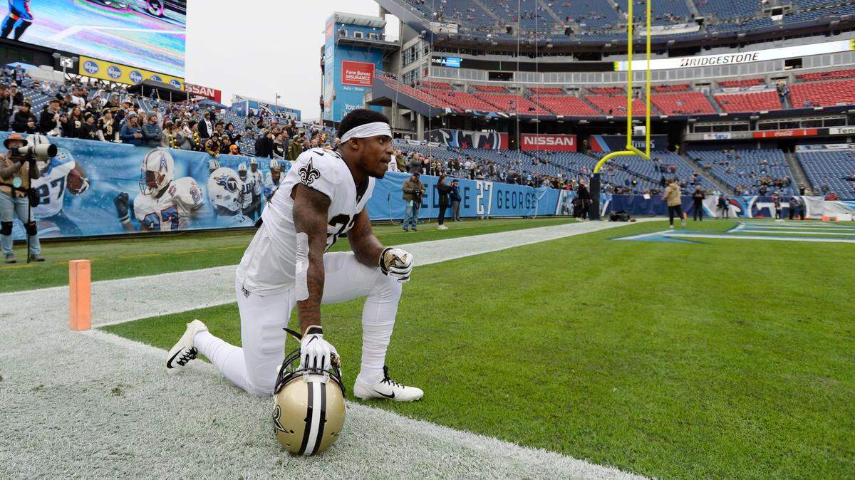 New Orleans Saints defensive back Chauncey Gardner-Johnson kneels on the field before an NFL football game against the Tennessee Titans Sunday, Dec. 22, 2019, in Nashville, Tenn. (AP Photo/Mark Zaleski)