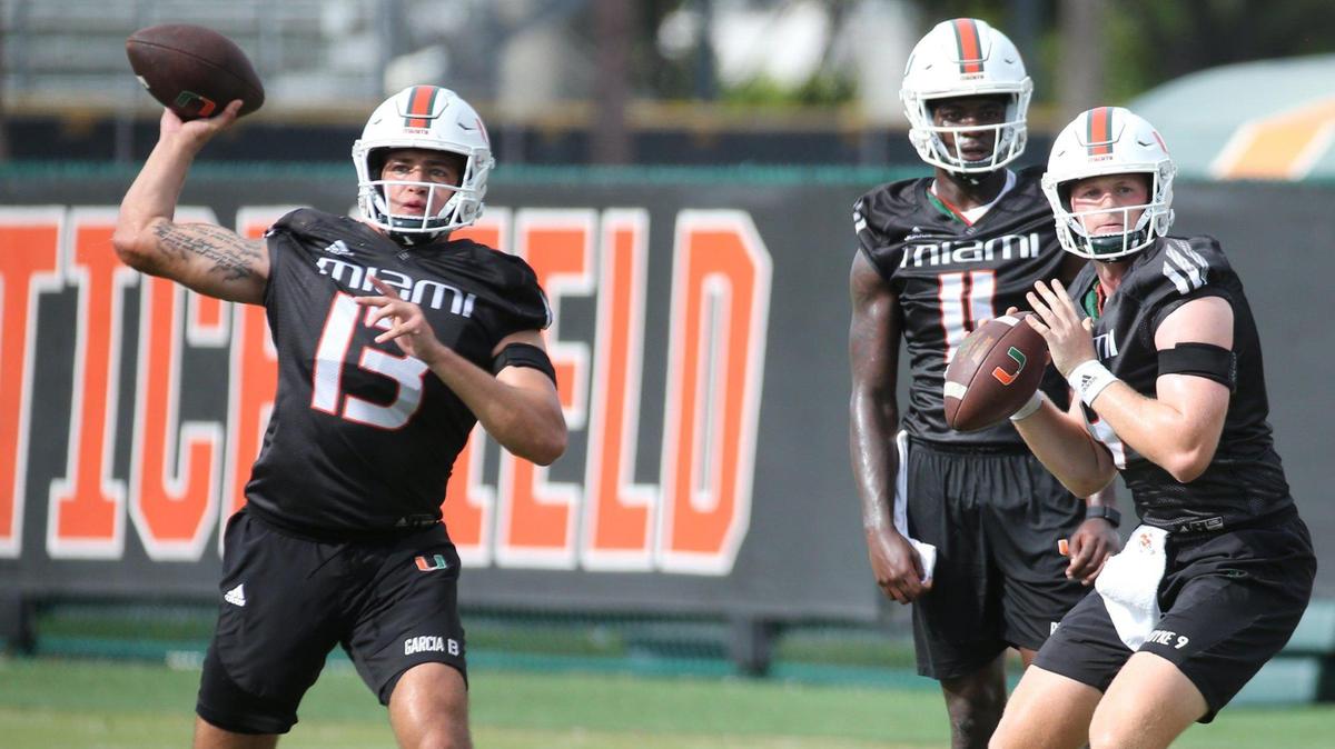 Miami Hurricanes quarterbacks Tyler Van Dyke (9) and Jake Garcia (13) set up to pass during practice drills at Greentree Practice Field at the University of Miami in Coral Gables on Friday, August 5, 2022.