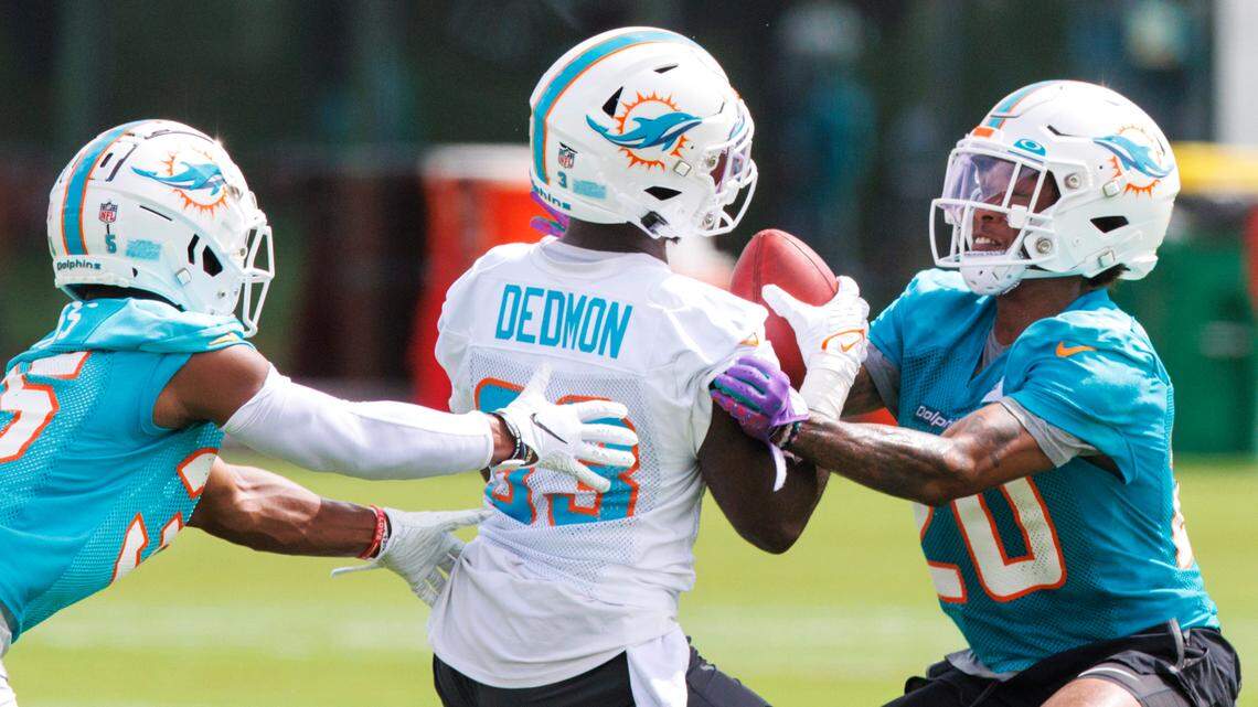 Miami Dolphins wide receiver DeVonte Dedmon (83) does drills with teammates defensive back D’Angelo Ross (35) and safety Sheldrick Redwine (20) during NFL football training camp at Baptist Health Training Complex in Hard Rock Stadium on Wednesday, July 27, 2022 in Miami Gardens, Florida.