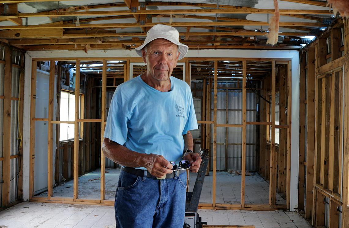 Vic Charnley stands in the living room of his Big Pine Key mobile home on Aug. 29, 2018. It was ruined by Hurricane Irma a year ago and he is waiting for a demolition permit before he can start rebuilding.