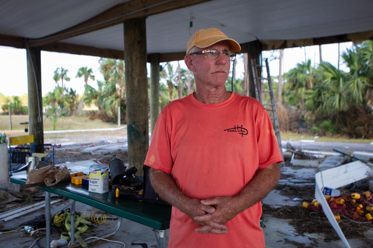 Clint Moore, 62, stands under the ruins of his wrecked two-story home in Simmons Bayou, Florida, eight days after Hurricane Michael devastated the area on Oct. 10, 2018. Moore lost his home and his family-owned shrimping business to the storm.