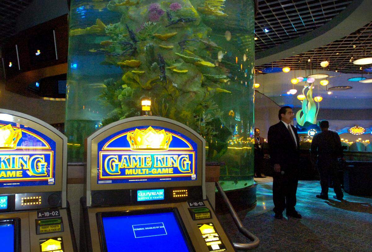 Don James, vice president of Gaming for Gulfstream Park Racing & Casino, stands before a 13,000 gallon aquarium in the new casino, which contains over 500 slot machines.