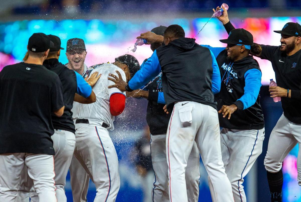 Miami Marlins players dump drinks and baby powder on teammate Jesús Aguilar (99) after he hit a walk-off single to allow base runner Willians Astudillo (37) to score during the tenth inning of an MLB game against the Washington Nationals at loanDepot park in the Little Havana neighborhood of Miami, Florida, on Wednesday, June 8, 2022. The Marlins defeated the Nationals 2-1.