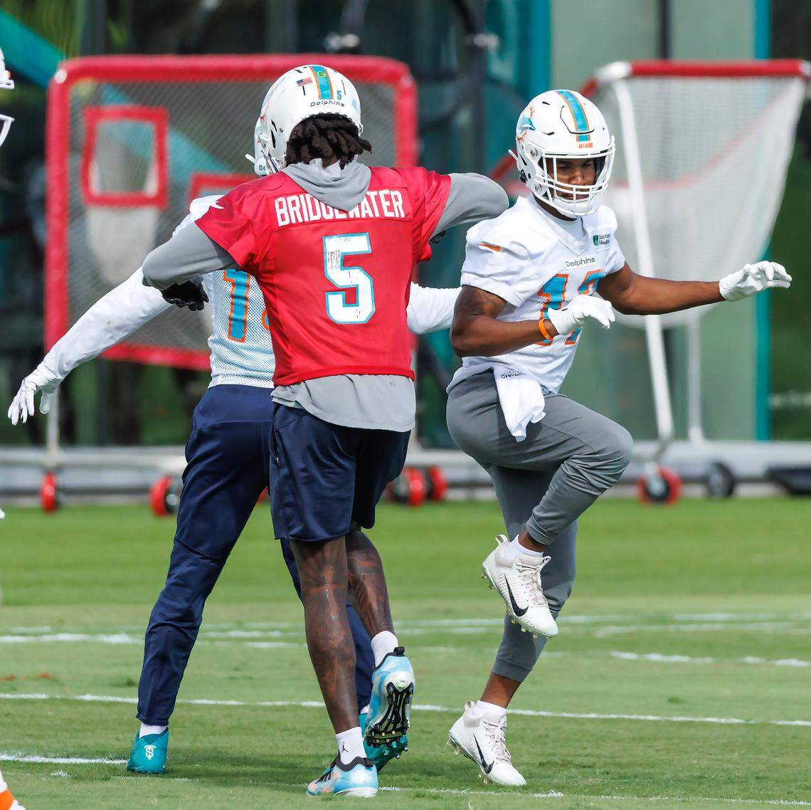 Miami Dolphins quarterback Teddy Bridgewater (5) interacts with teammate Jaylen Waddle (17) during practice at Baptist Health Training Complex in Hard Rock Stadium on Wednesday, December 28, 2022 in Miami Gardens, Florida.