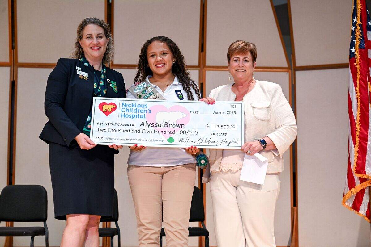 Chelsea Wilkerson and Dawn Javersack present Alyssa Brown, center, with her Girl Scout Gold Award.