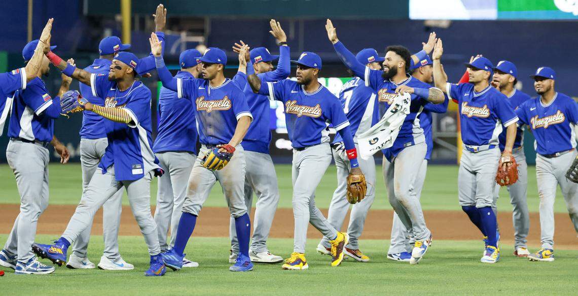 The Venezuela team celebrate after defeating Japan at the World Baseball Classic quarter finals at loanDept park on Saturday, March 14, 2026.